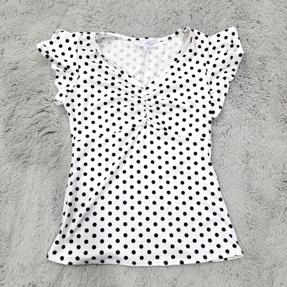 White top, navy blue polka dots